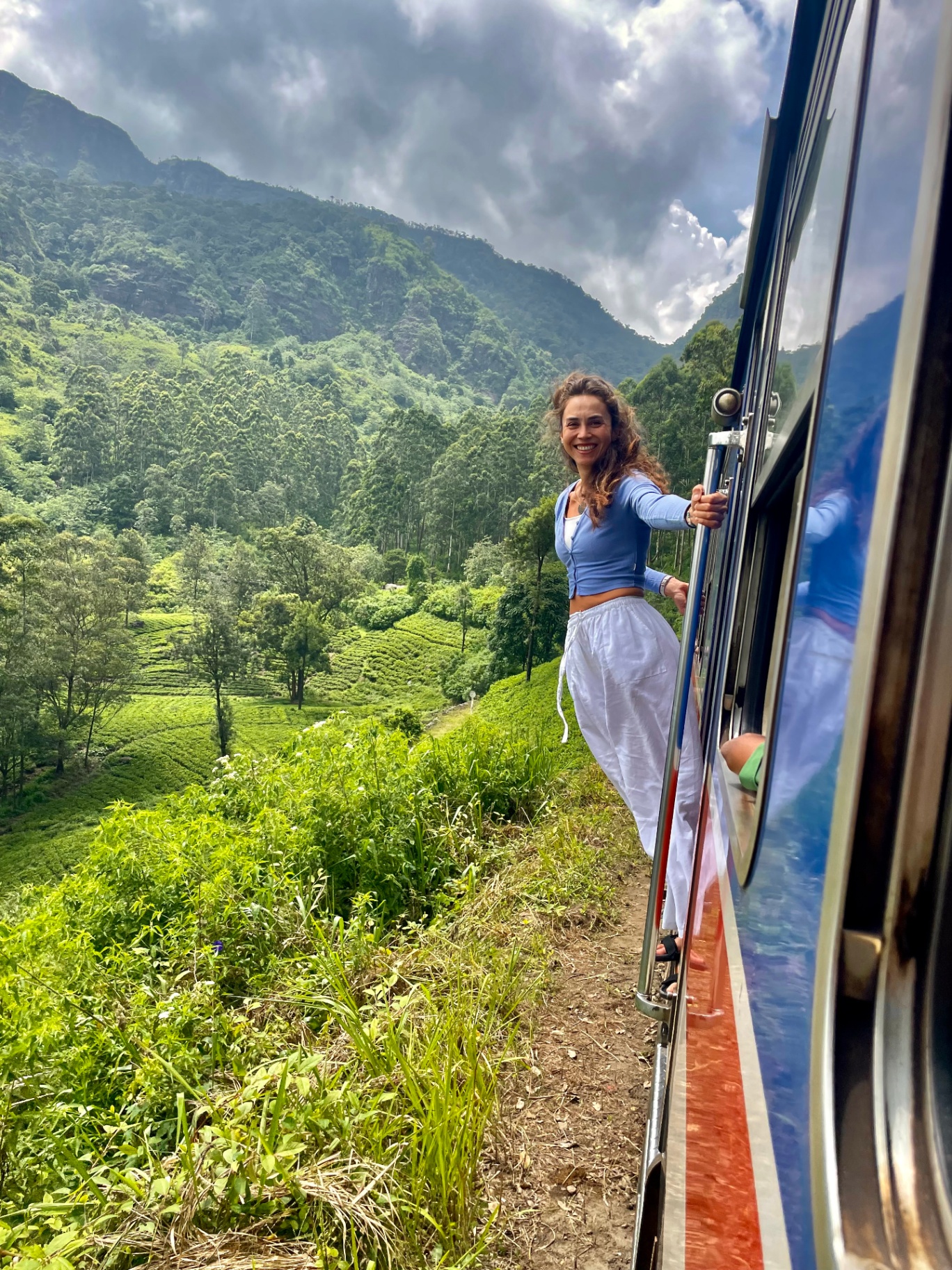 Leaning out of a train through the Sri Lankan tea highlands
